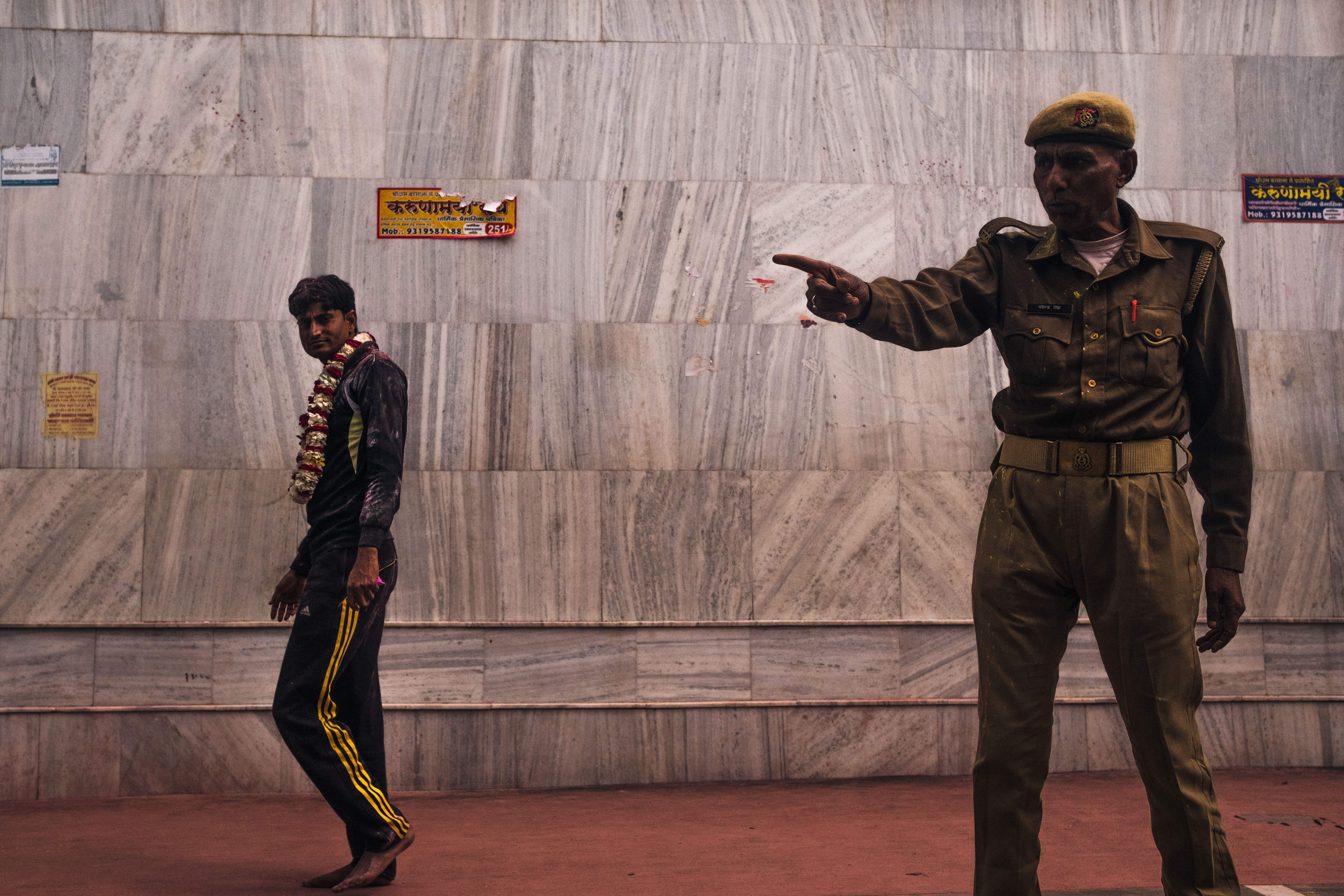 India Street Photography During Holi Festival. security guard asks panhandlers to leave the temple . Images by Jason Vinson