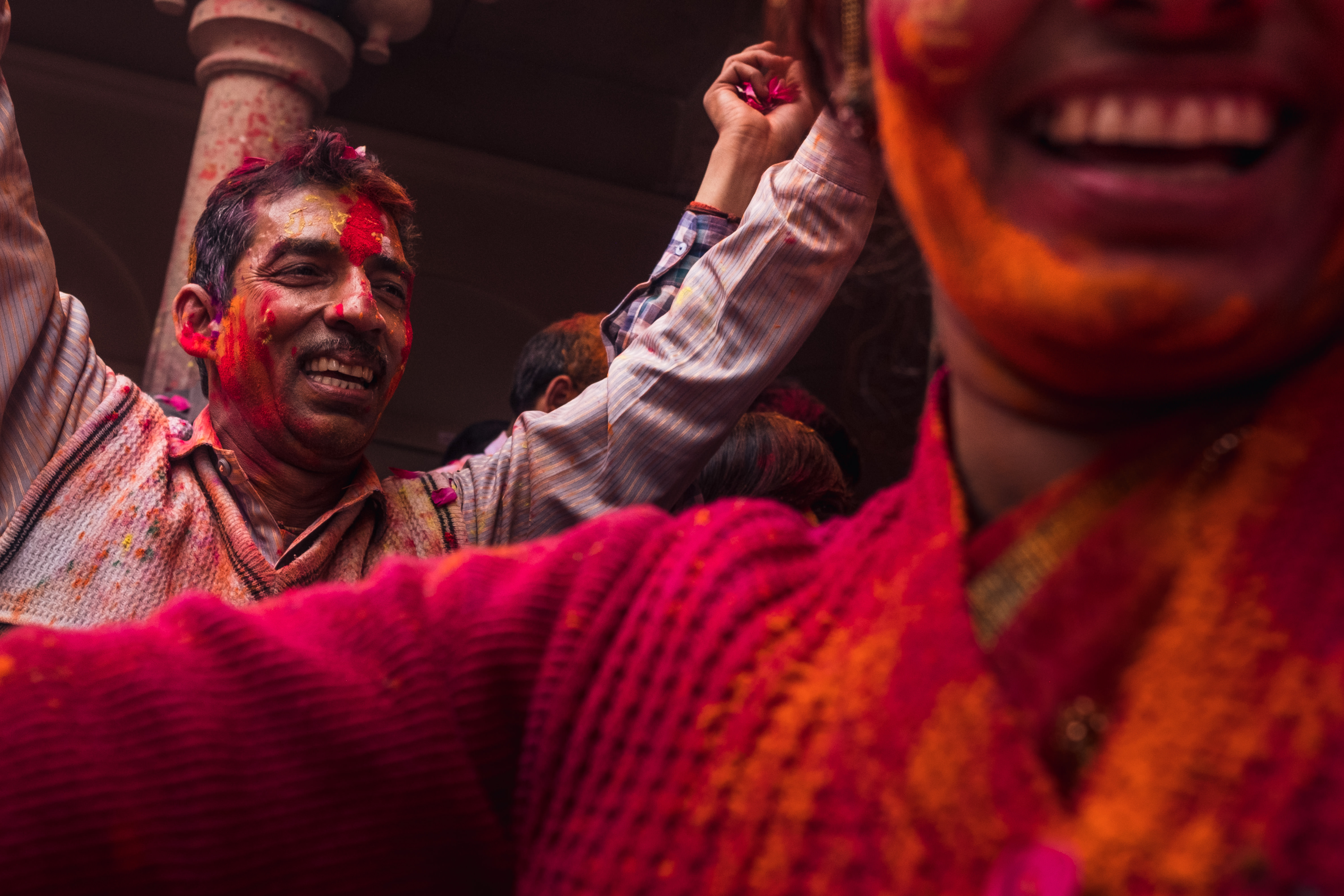 India Street Photography During Holi Festival. Man and woman laugh as the celebrate. Images by Jason Vinson
