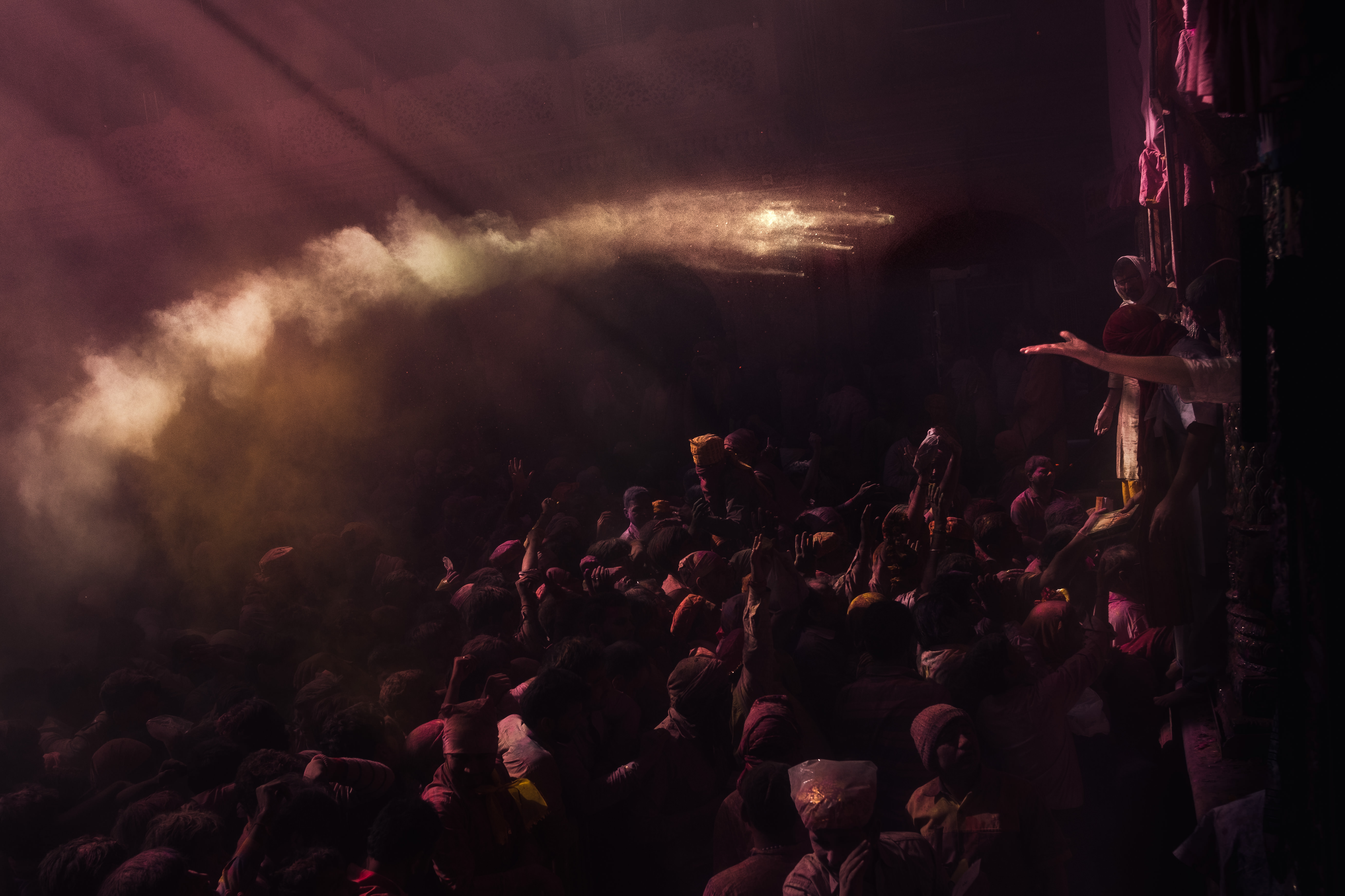 India Street Photography During Holi Festival. flying powder appears to be landing in outreached hand. Images by Jason Vinson