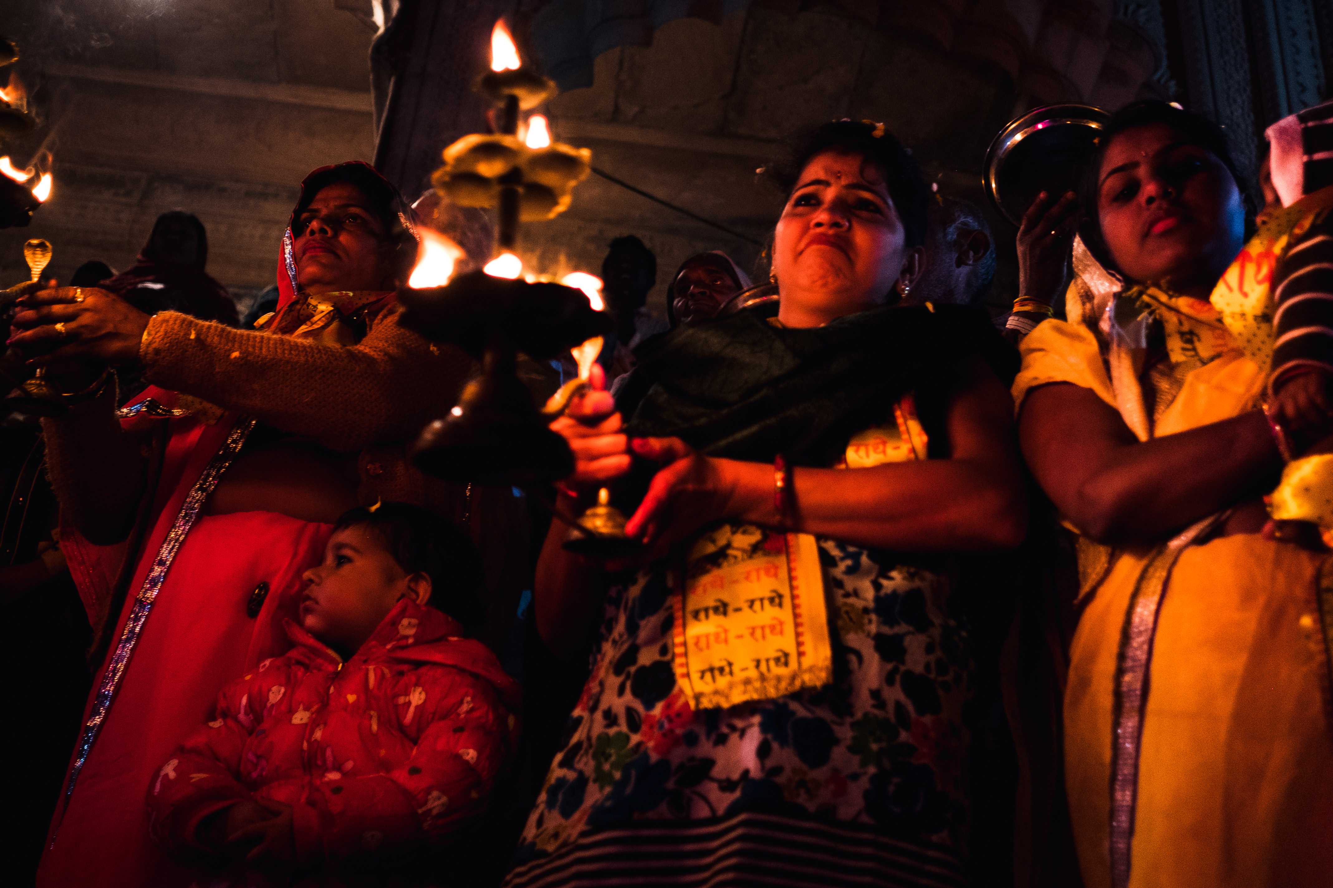 India Street Photography During Holi Festival. Lady cries during prayer. Images by Jason Vinson