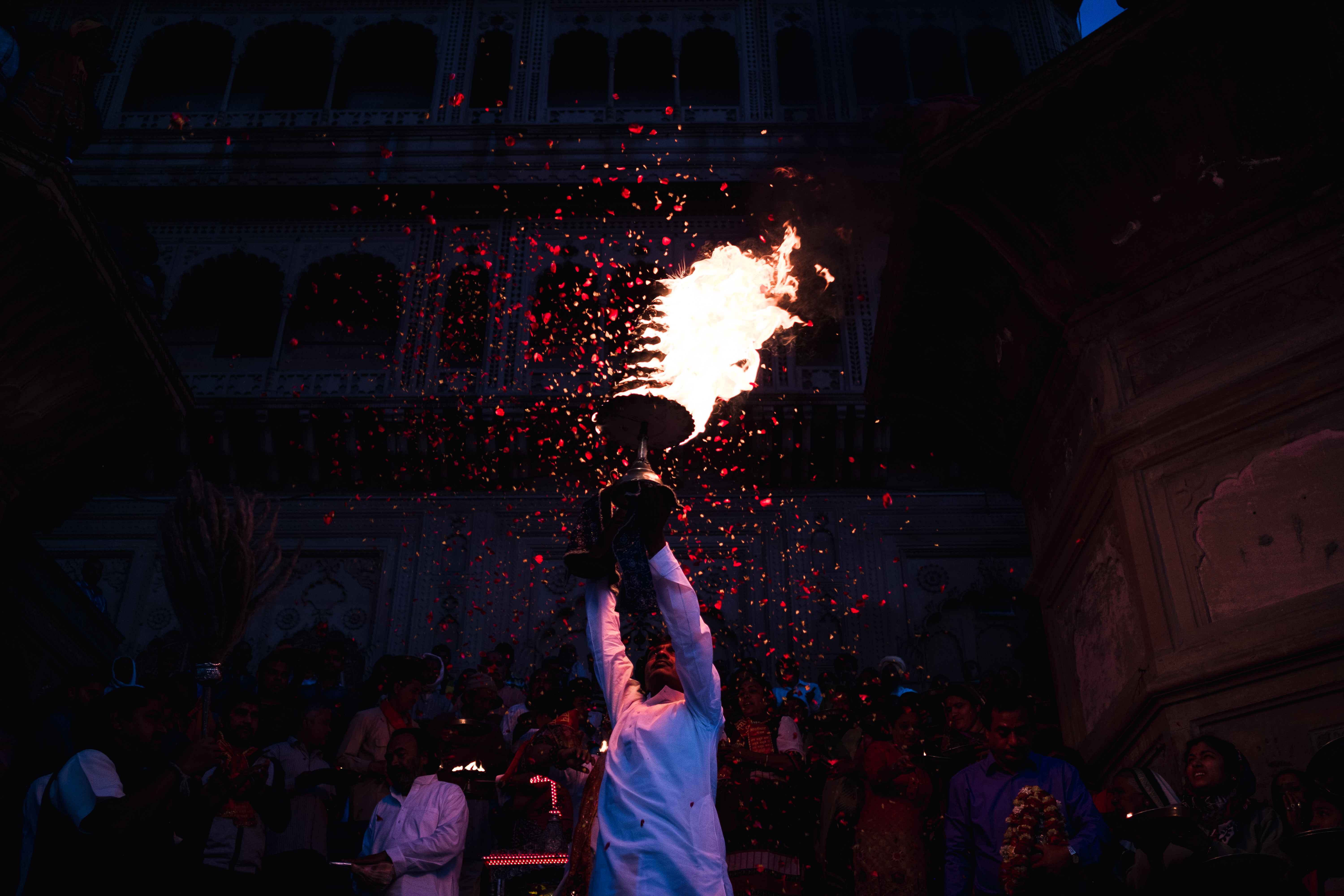 India Street Photography During Holi Festival. rose pedals thrown over fire. Images by Jason Vinson