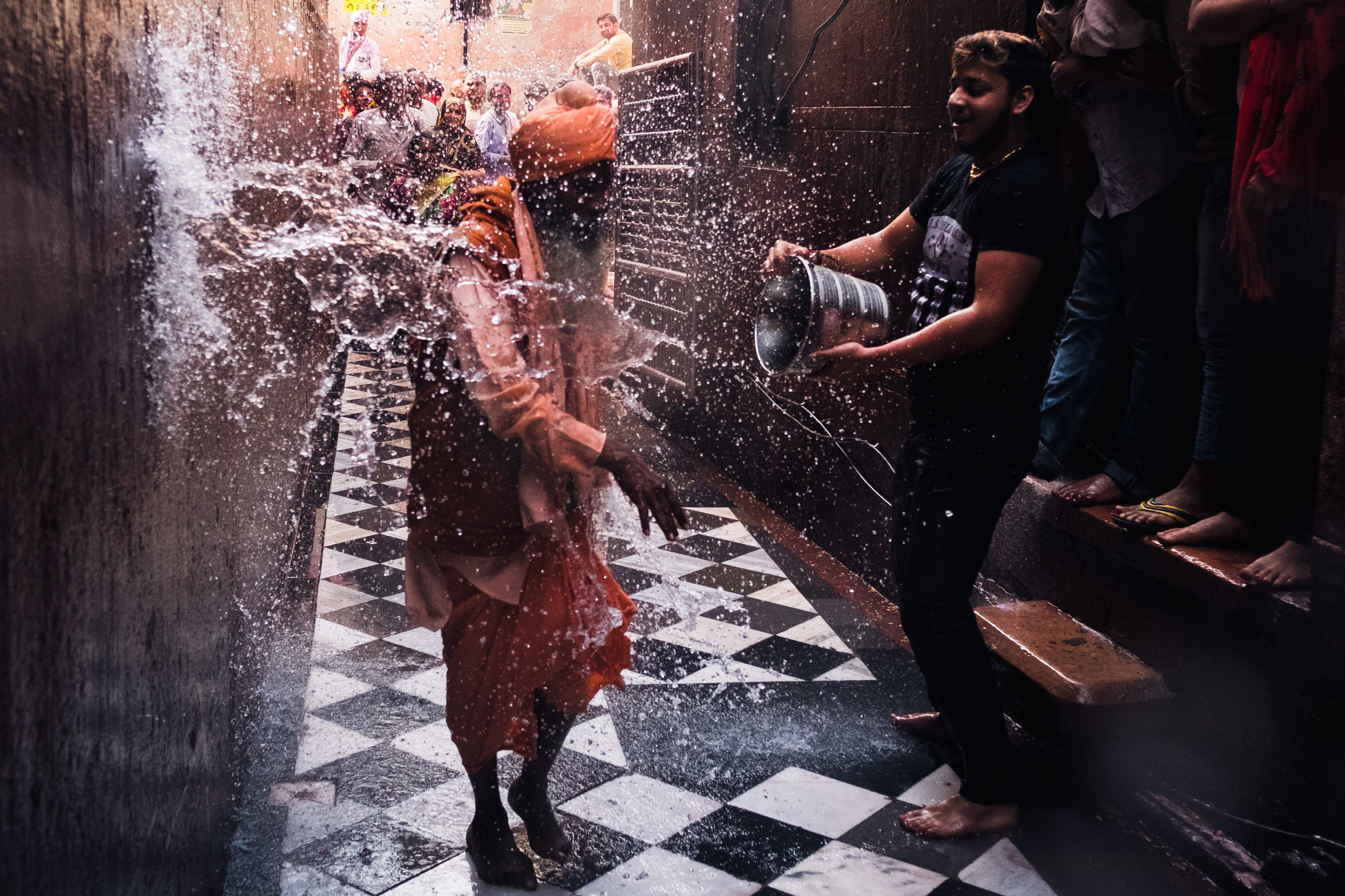 India Street Photography During Holi Festival. Priest gets drenched in water. Images by Jason Vinson