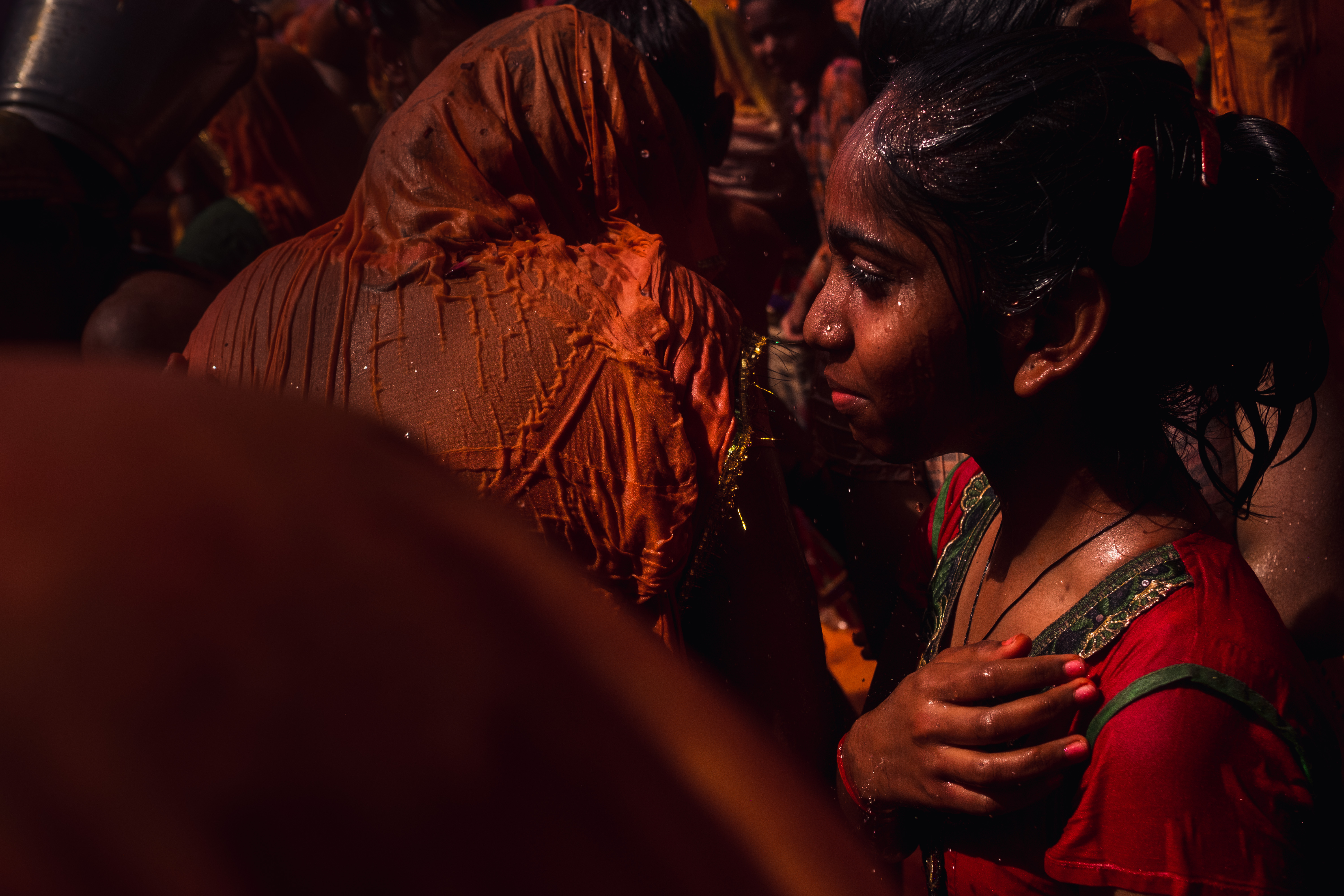 India Street Photography During Holi Festival. girl holds her hand to her chest. Images by Jason Vinson