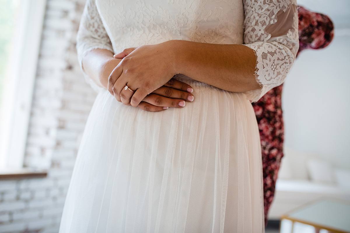 Centerton-Arkansas-Wedding-The-Ravington-NWA-Wedding-brides-folded-hands-on-dress
