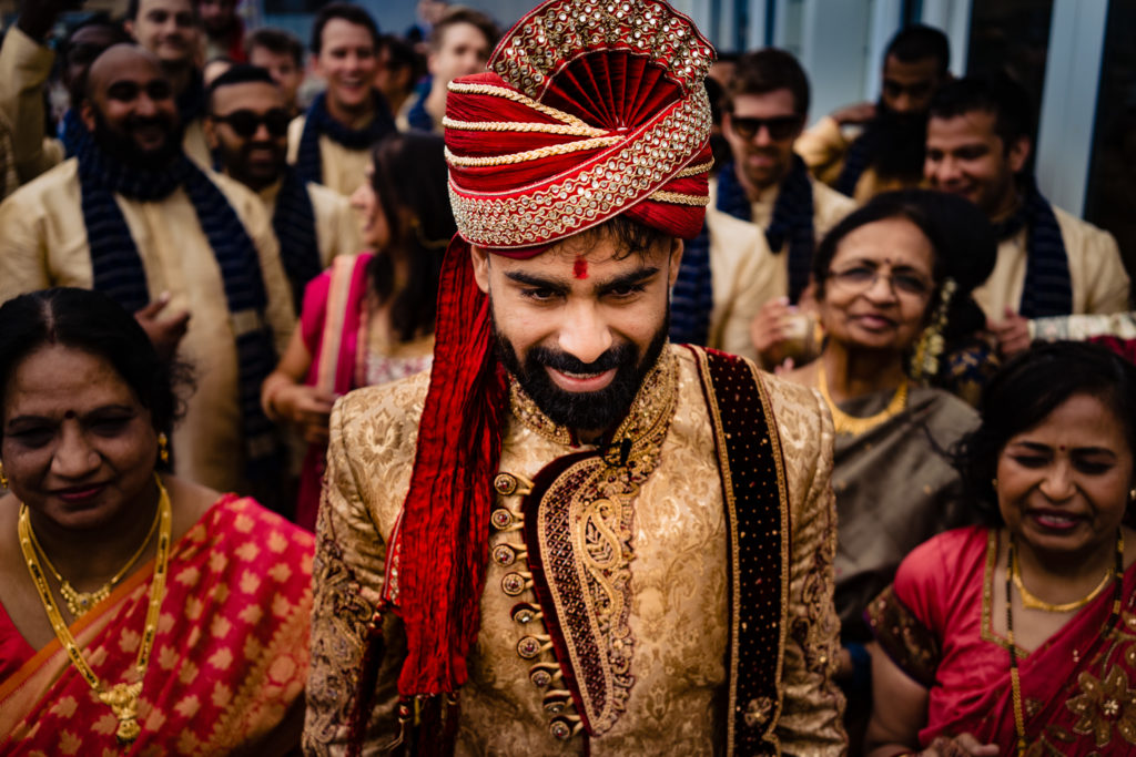 Northwest Arkansas Indian Wedding Photography Vinson Images-groom standing at the front of his Baraat before ceremony starts 