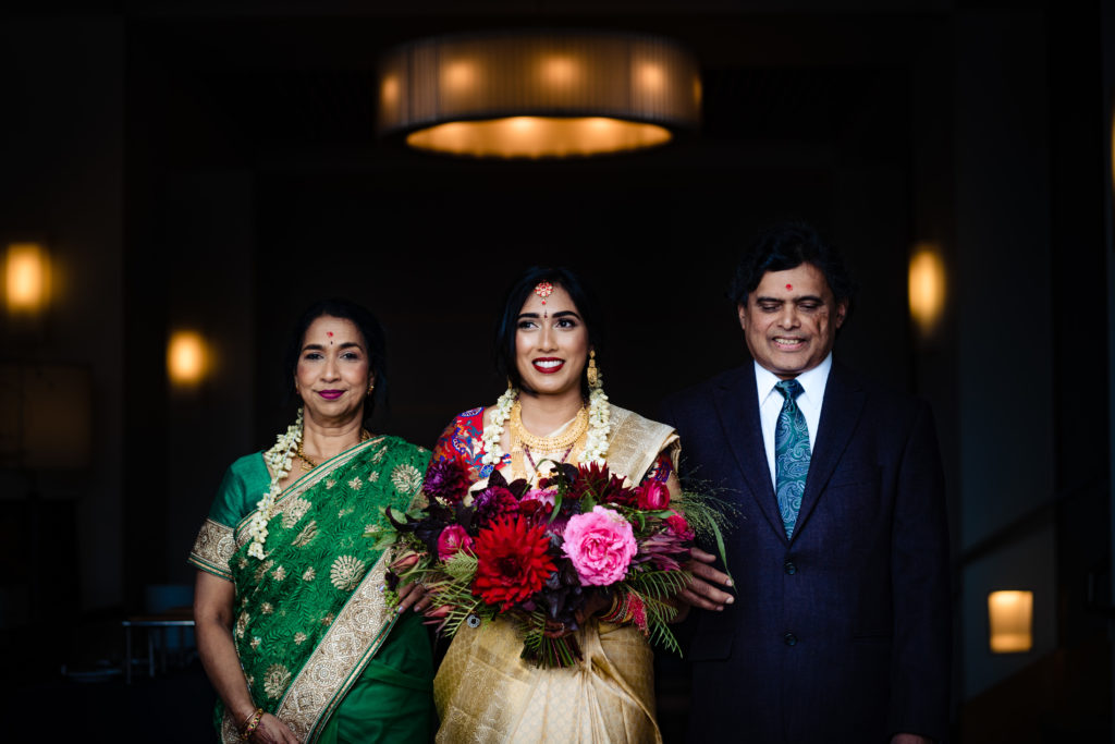 Northwest Arkansas Indian Wedding Photography Vinson Images- bride with her parents prepare to walk down the aisle 