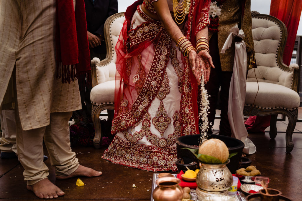 Northwest Arkansas Indian Wedding Photography Vinson Images- bride gently places rice into the fire 