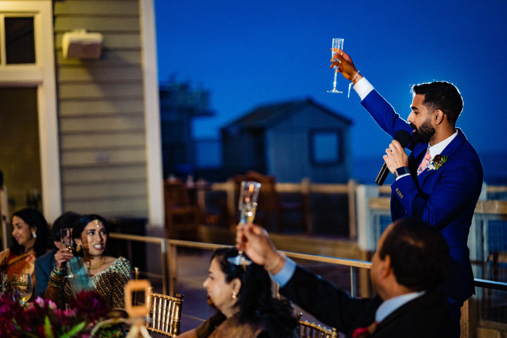 Northwest Arkansas Indian Wedding Photography Vinson Images- groom raises champagne glass to cheers everyone 