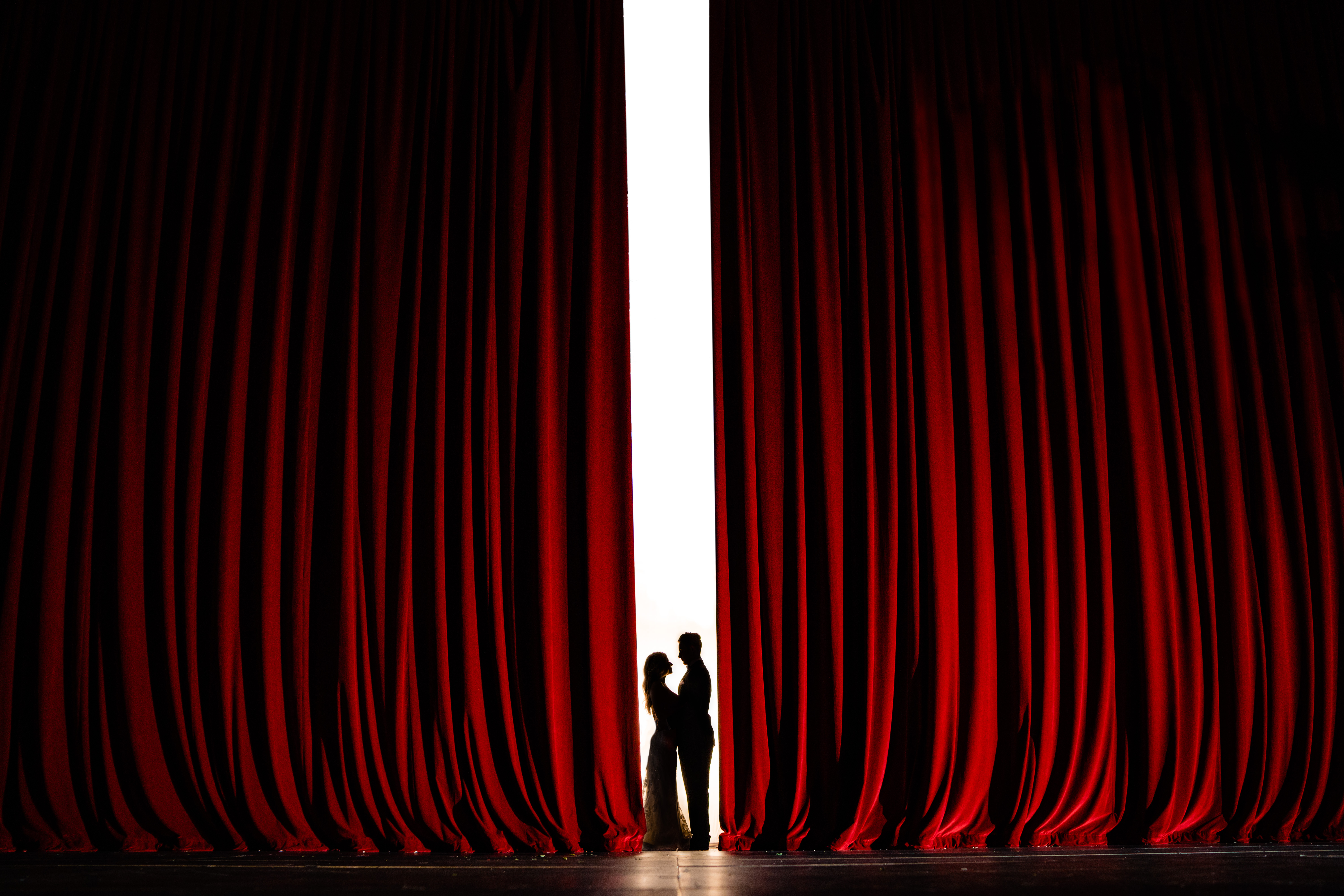 Walton Arts center wedding by Vinson Images - Northwest Arkansas Wedding photography - red curtain silhouette couple portrait