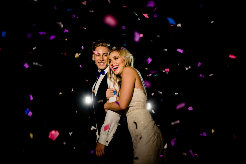 Walton Arts center wedding by Vinson Images - Northwest Arkansas Wedding photography - couple laughing in confetti