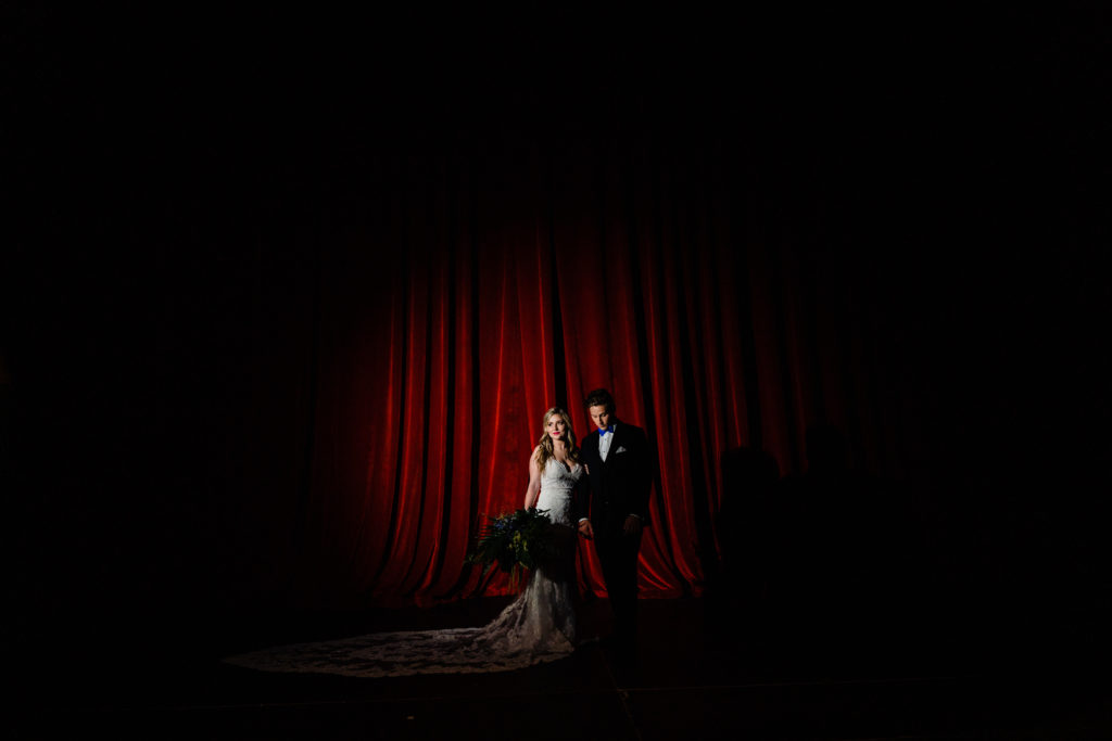 Walton Arts center wedding by Vinson Images - Northwest Arkansas Wedding photography - red curtain spot light