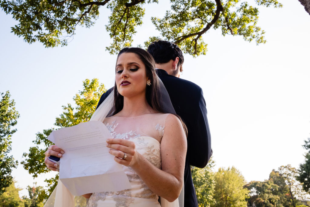 Fayetteville Arkansas Wedding - Old Main Lawn ceremony - bride reads a note to the groom