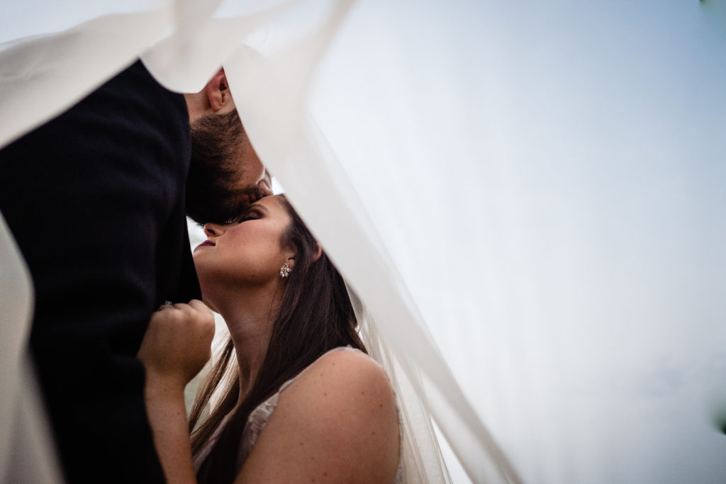 Fayetteville Arkansas Wedding - Old Main Lawn ceremony - groom kissed bride on forehead under veil