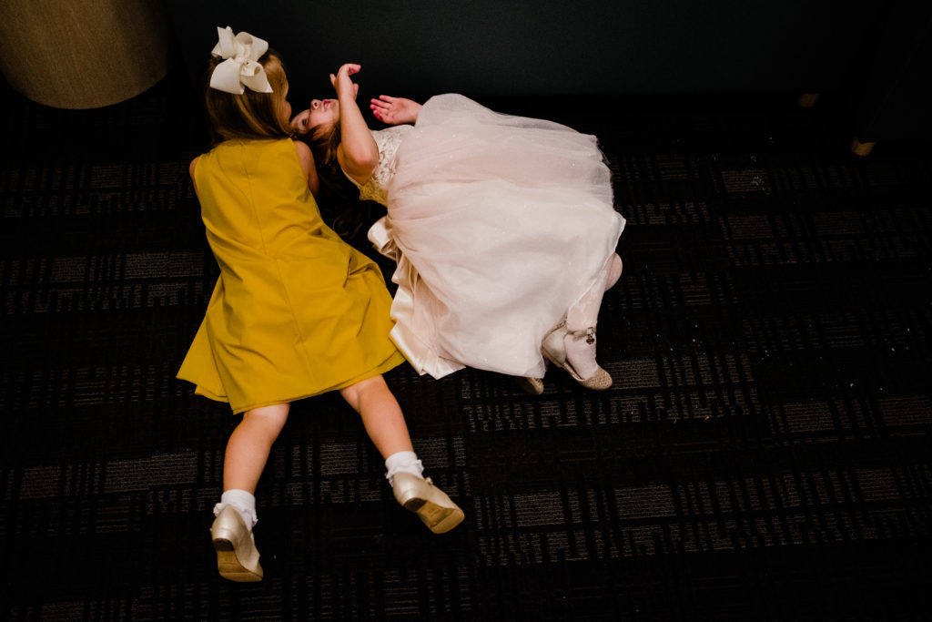 Vinson Images - Walton Arts Center Wedding - flower girls roll on the ground