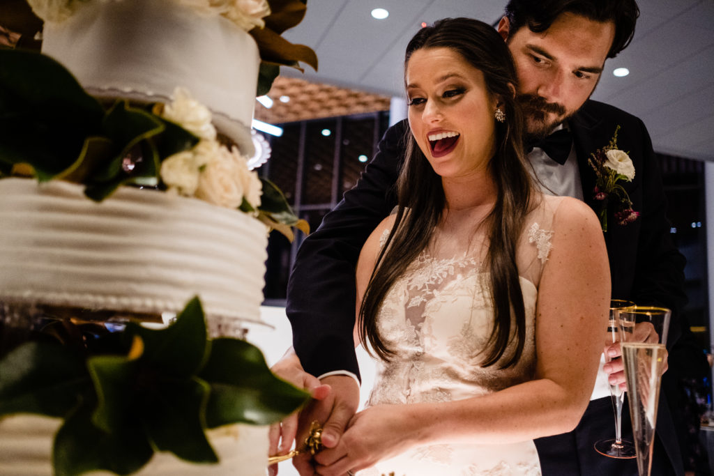 Vinson Images - Walton Arts Center Wedding - bride laughs as they cut the cake