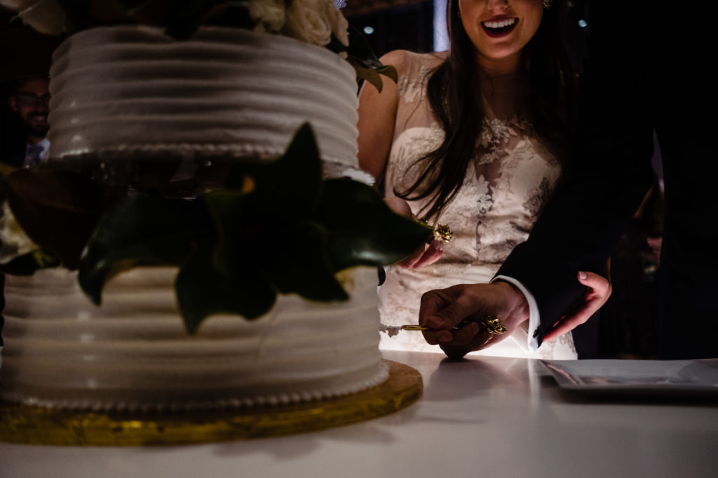 Vinson Images - Walton Arts Center Wedding - bride and groom cut the cake