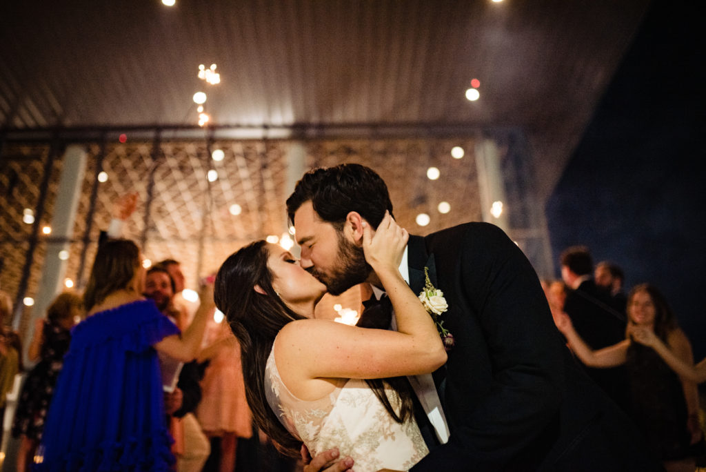 Vinson Images - Walton Arts Center Wedding - bride and groom kiss after exit