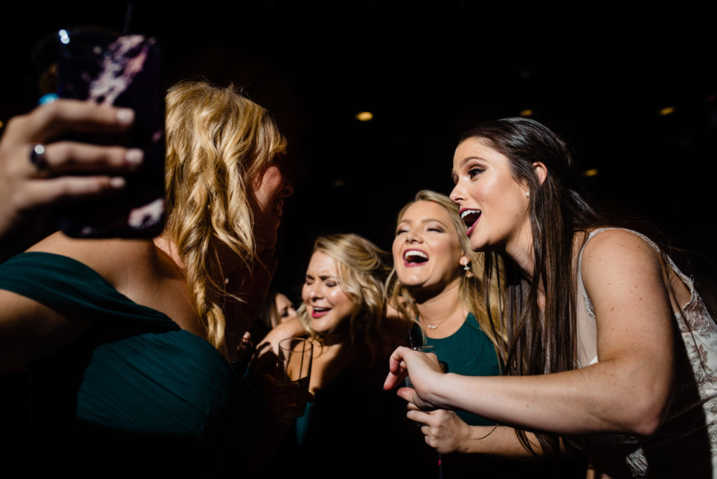Vinson Images - Walton Arts Center Wedding - bride and bridesmaids singing at reception