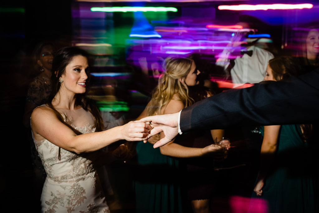 Vinson Images - Walton Arts Center Wedding - bride and groom dance with colored lights