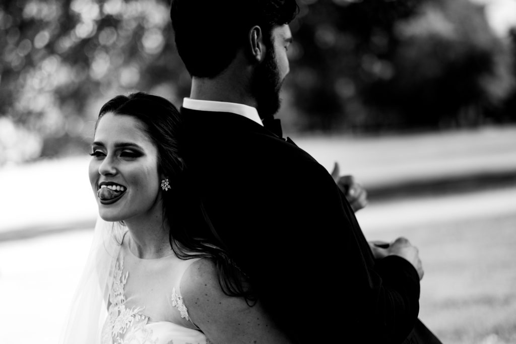 Fayetteville Arkansas Wedding - Old Main Lawn ceremony - bride playfully stick out her tongue