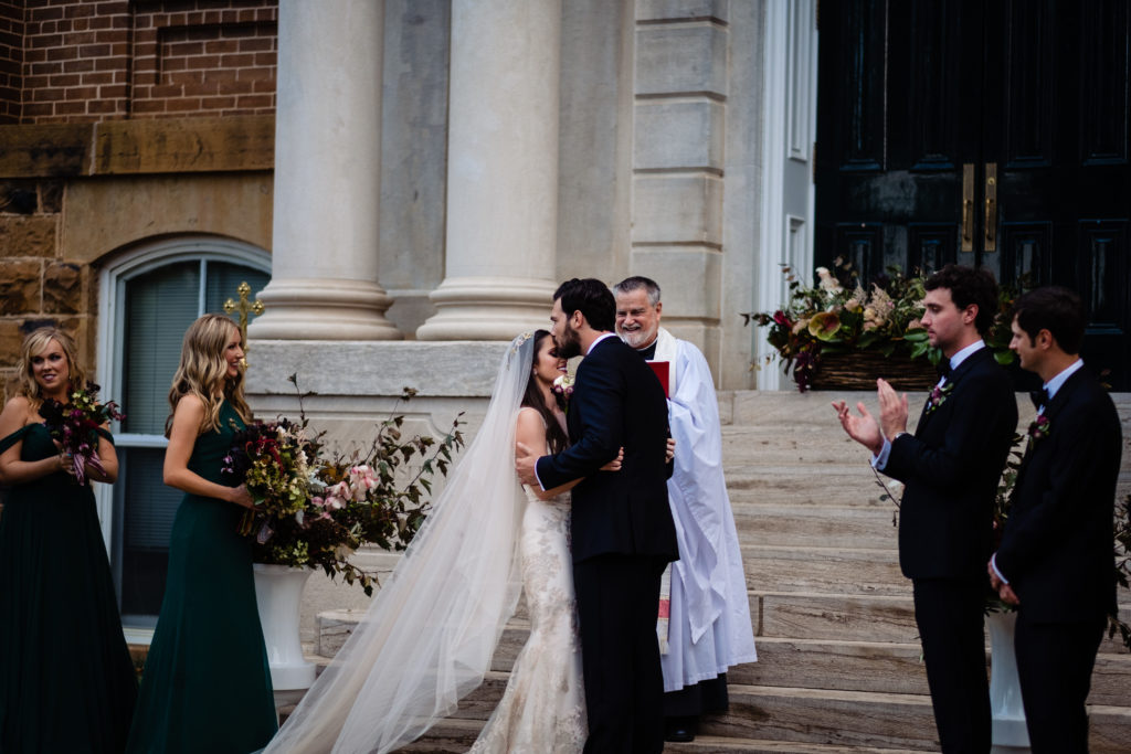 Fayetteville Arkansas Wedding - Old Main Lawn ceremony - groom skisses bride on forehead after ceremony