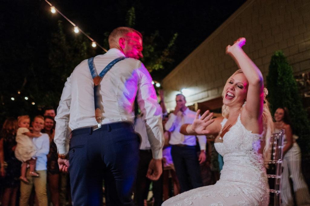 The Stone Chapel At Matt Lane Farms - Fayetteville Arkansas wedding - bride dance as the groom comes to get the garter