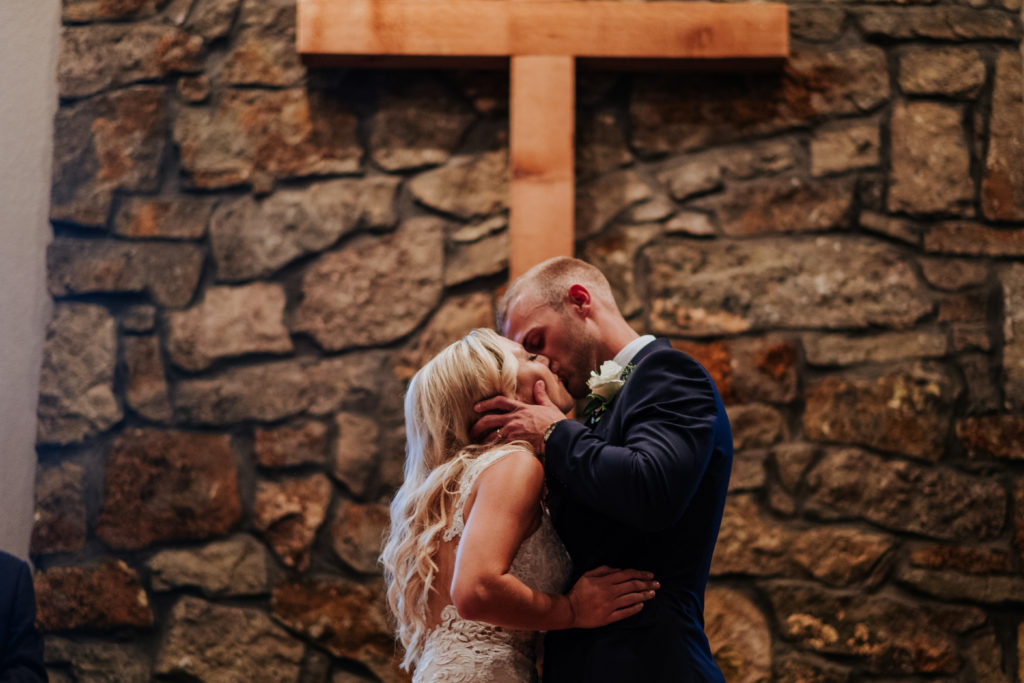 The Stone Chapel At Matt Lane Farms - Fayetteville Arkansas wedding - first kiss for the bride and groom 