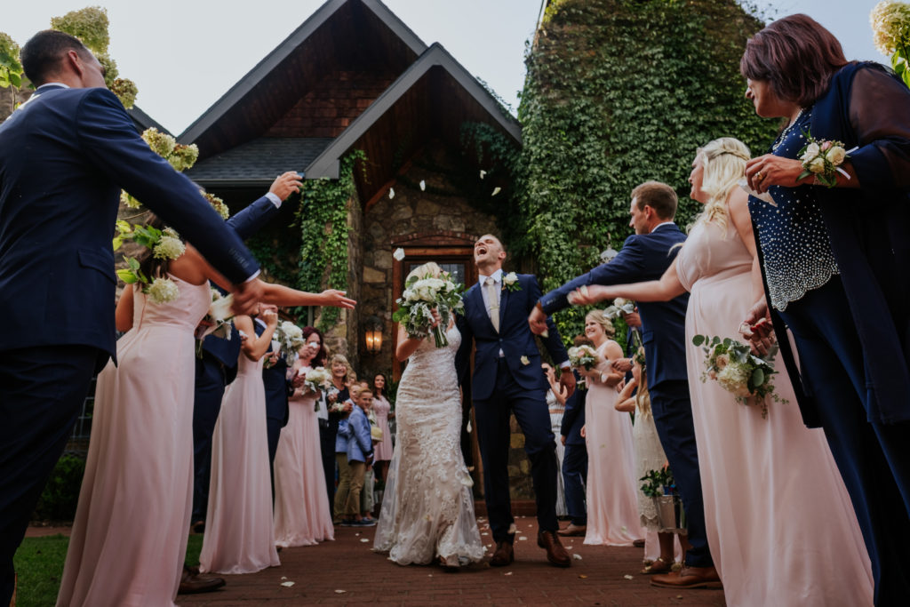 The Stone Chapel At Matt Lane Farms - Fayetteville Arkansas wedding - groom tries to catch flower pedals as they exit ceremony