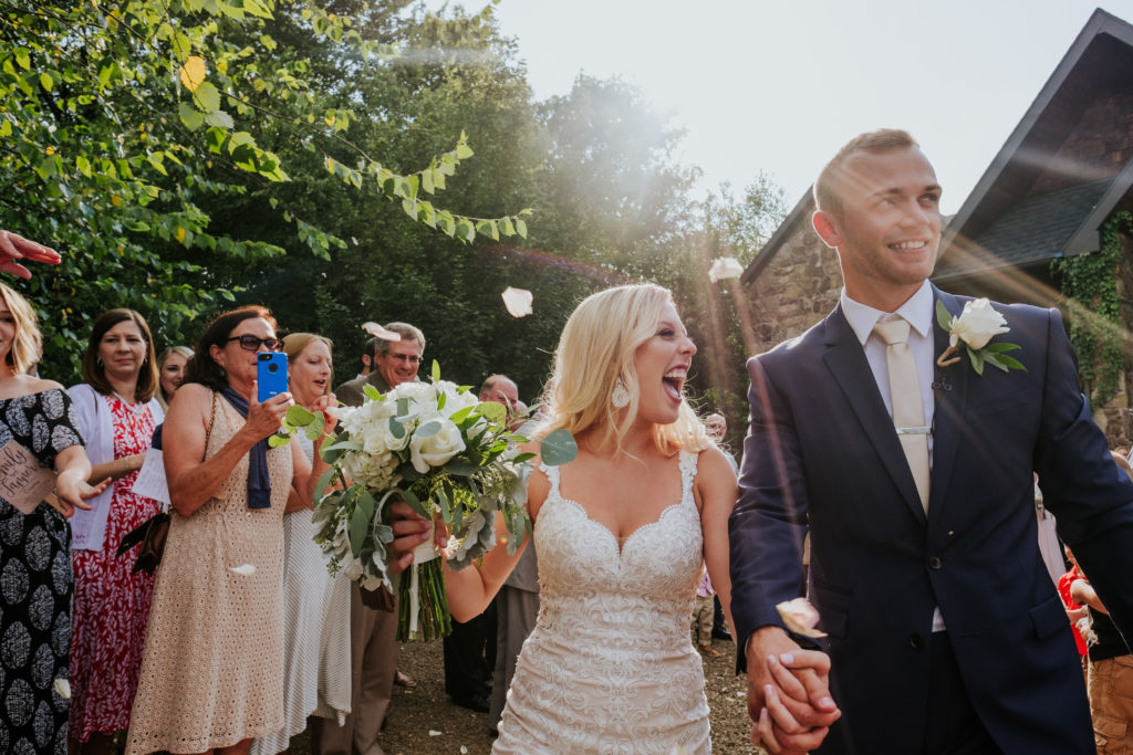 The Stone Chapel At Matt Lane Farms - Fayetteville Arkansas wedding - bride and groom laugh as they leave the ceremony