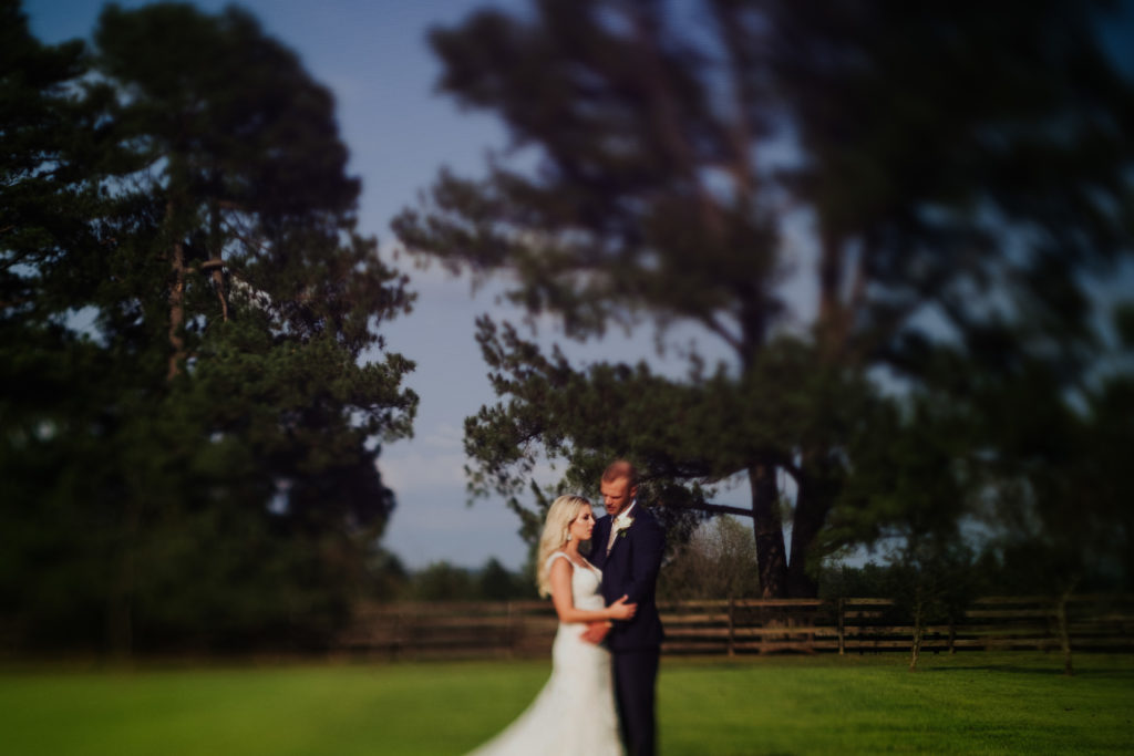 The Stone Chapel At Matt Lane Farms - Fayetteville Arkansas wedding - bride and groom portrait in open field