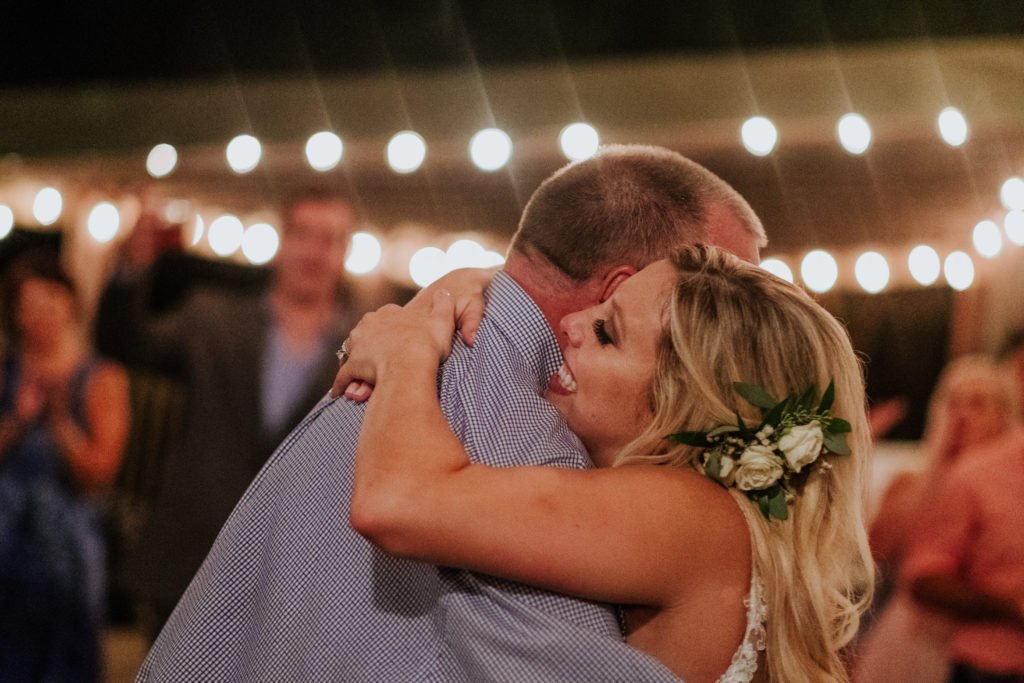 The Stone Chapel At Matt Lane Farms - Fayetteville Arkansas wedding - bride hugs her dad after their dance 