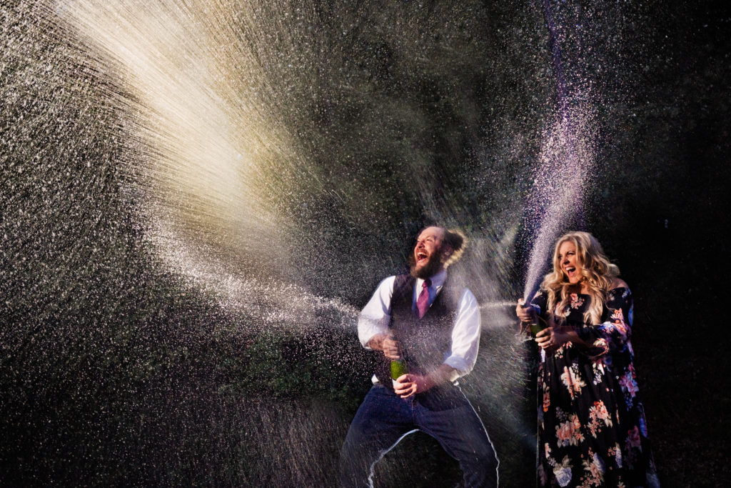 Northwest Arkansas Wedding Photography - Vinson Images - Beaver lake Engagement - Spraying champagne