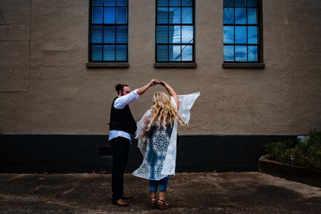 Northwest Arkansas Wedding Photography - Vinson Images - Downtown Rogers Engagement - couple dancing in alley way 