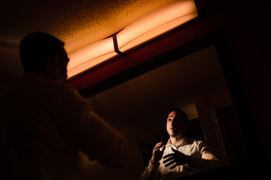 Northwest Arkansas Wedding photography - Vinson Images - groom doing his hair in the mirror
