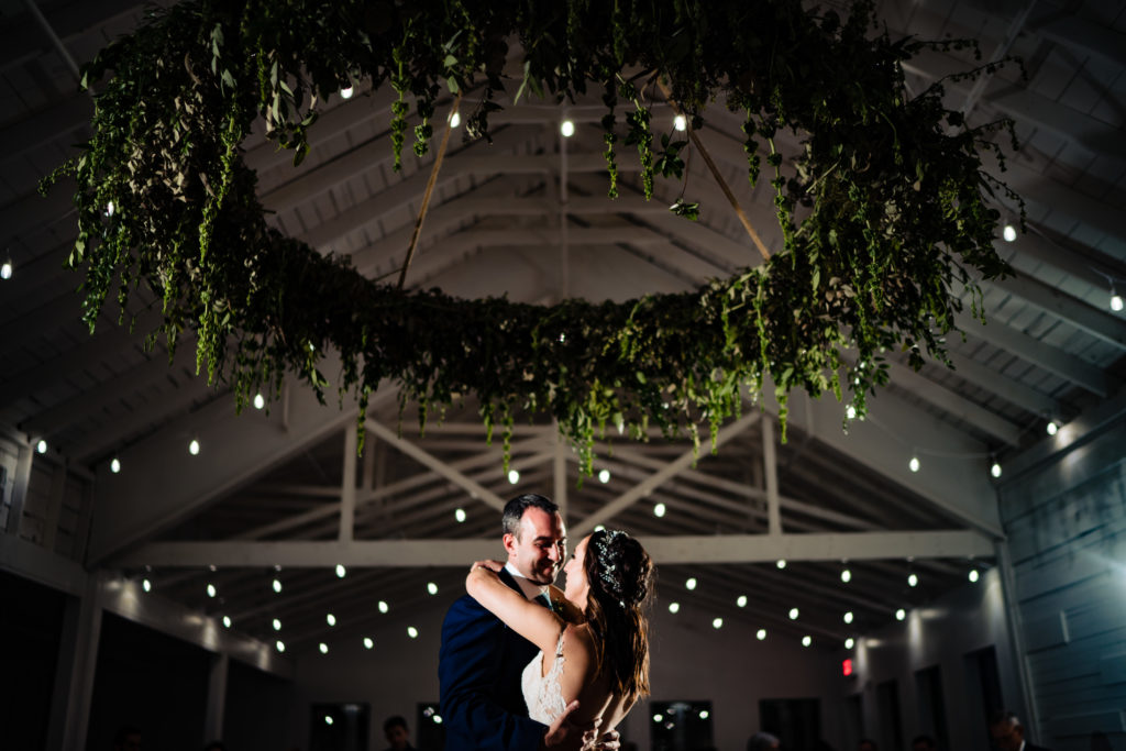 Kindred North Wedding - Northwest Arkansas Wedding - Vinson Images - bride and groom under chandelier 