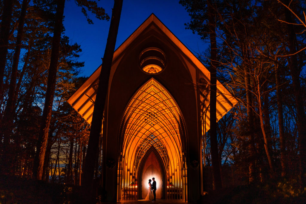 Creative wedding portrait after sunset with the Mildred B. Cooper glass chapel as the background