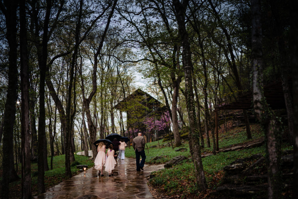 Wedding party approaches Thorncrown Glass chapel in Eureka Springs Arkansas 