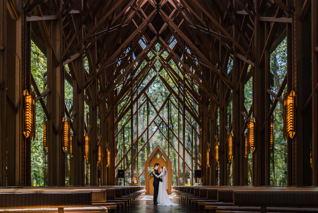  wedding couple poses in Anthony Chapel in Hot Springs Arkansas