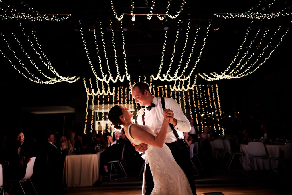 groom dip his bride during their first dance at The Momentary Wedding Venue