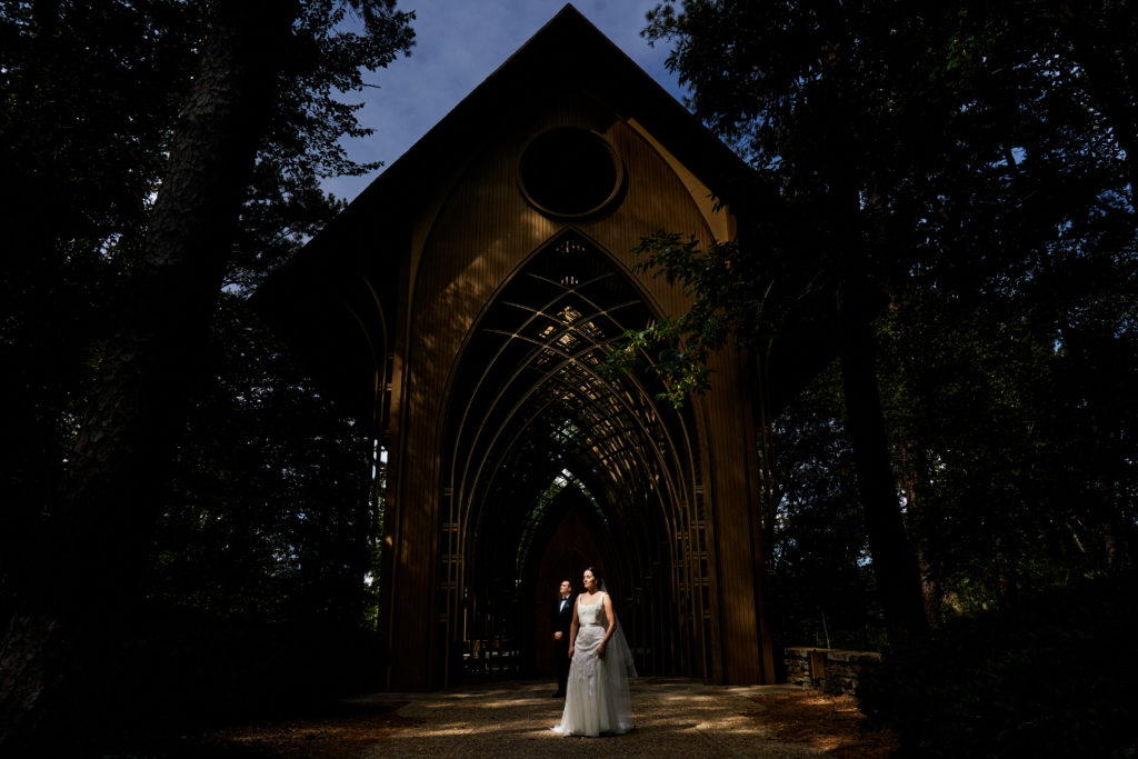 Couple poses for portrait in front of Mildred b Cooper chapel before their reception at The Momentary Wedding Venue