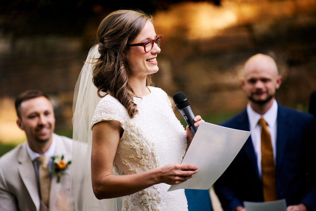 Wedding ceremony speech on the Frank Lloyd Wright Bachman-Wilson House lawn at Crystal Bridges