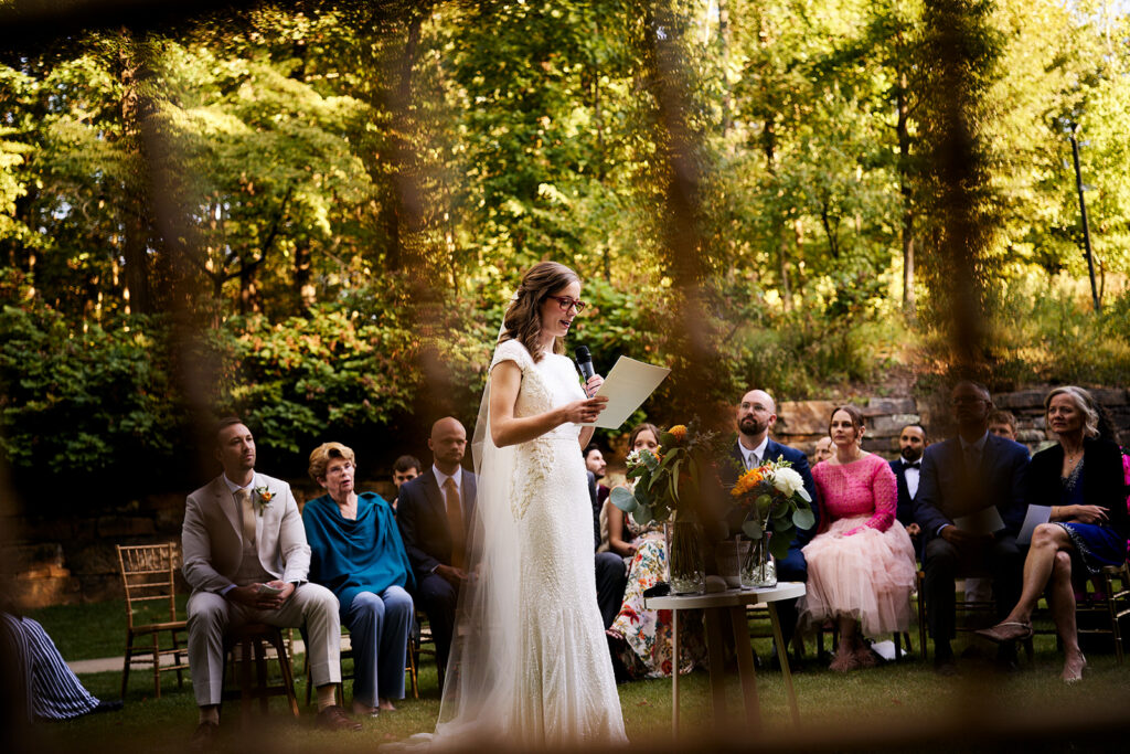 Wedding ceremony speech on the Frank Lloyd Wright Bachman-Wilson House lawn at Crystal Bridges