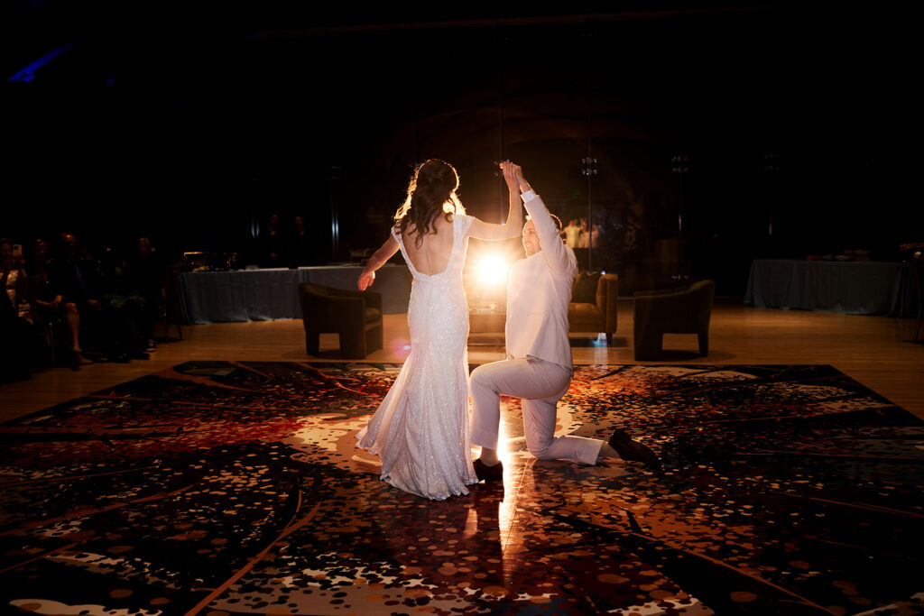 Newlyweds' first dance under the pine-beamed ceilings of the Great Hall at Crystal Bridges Museum.