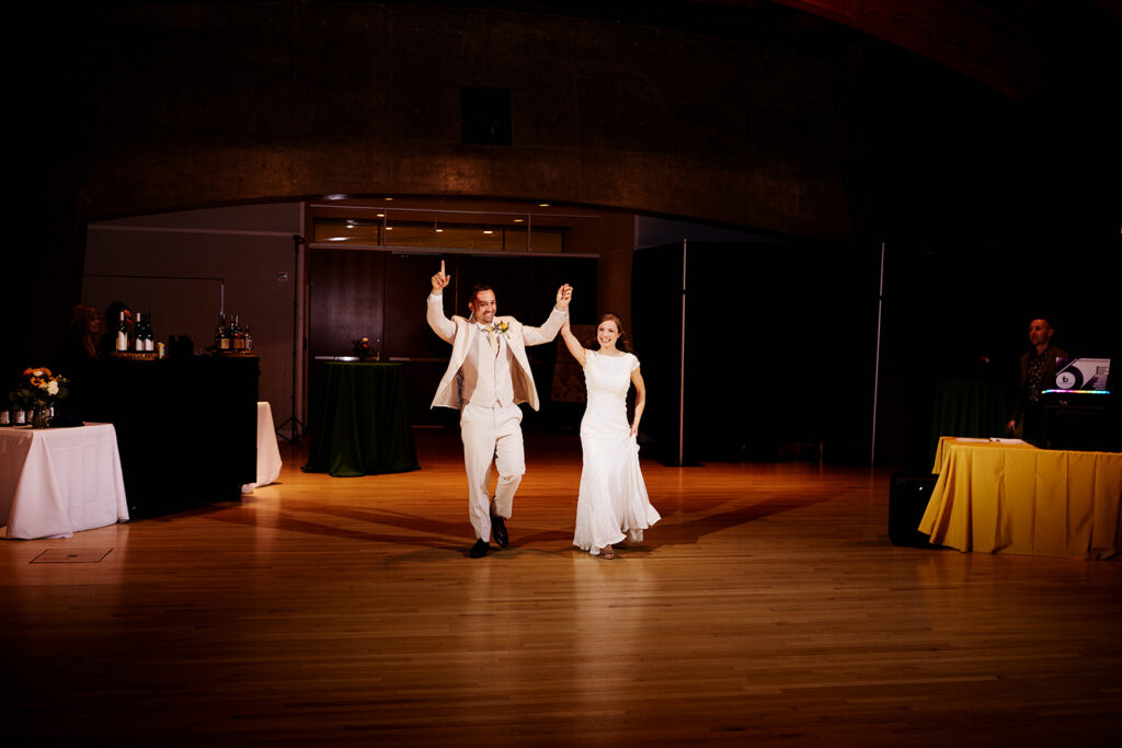 Bride and groom enter their Crystal Bridges Wedding reception 